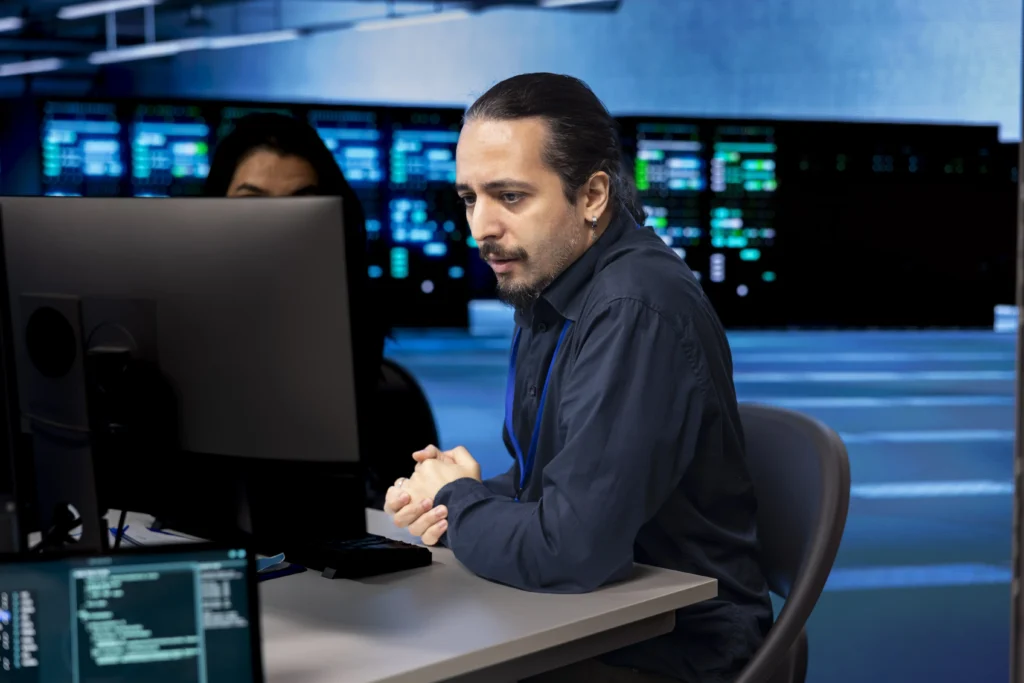 Is CompTIA Security+ Certification Worth It Today 3 coworkers looking errors causing infrastructure slow down